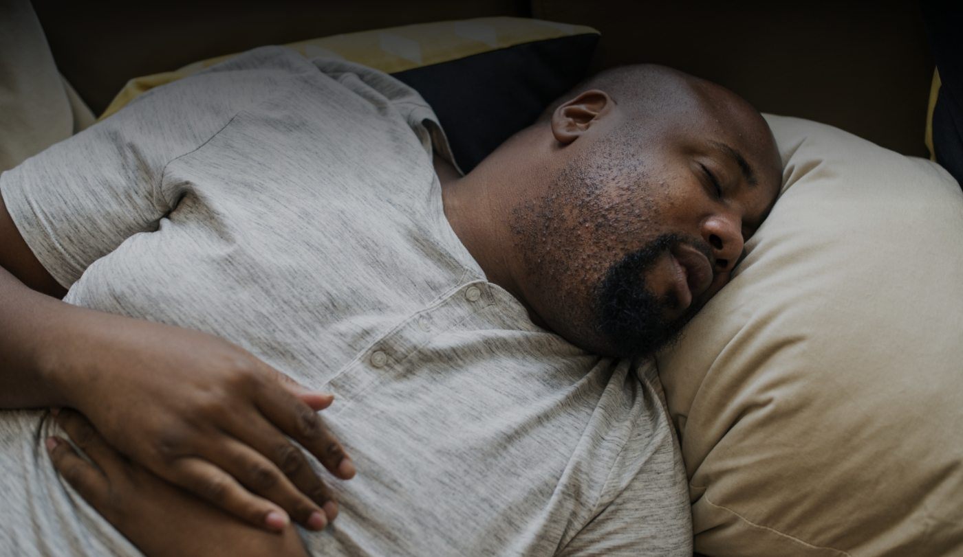 Man resting soundly after sleep apnea diagnosis and treatment