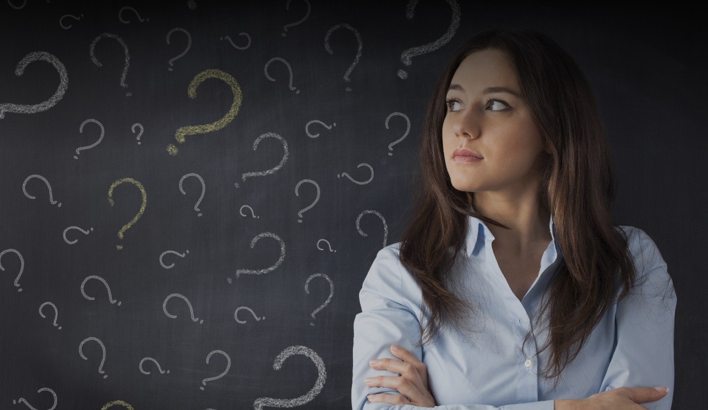 Woman surrounded by questionmarks representing frequently asked questions