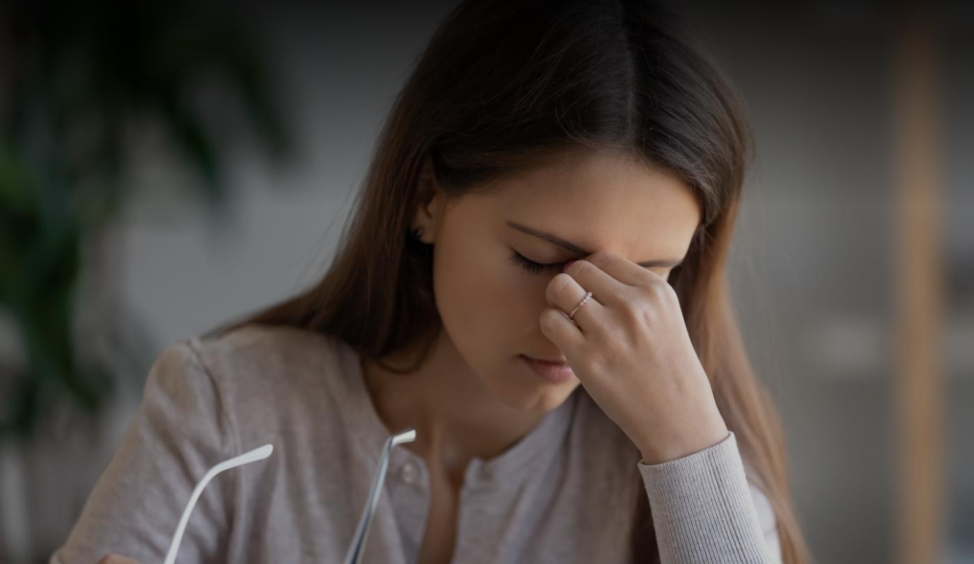 Woman experiencing headaches and migraines before treatment