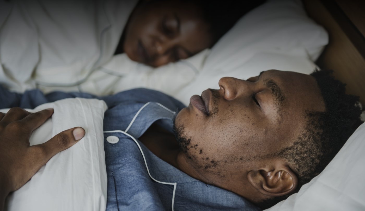 Man sleeping soundly with oral appliance therapy for sleep apnea