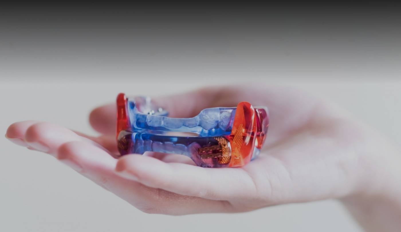 Hand holding a Respire sleep apnea oral appliance