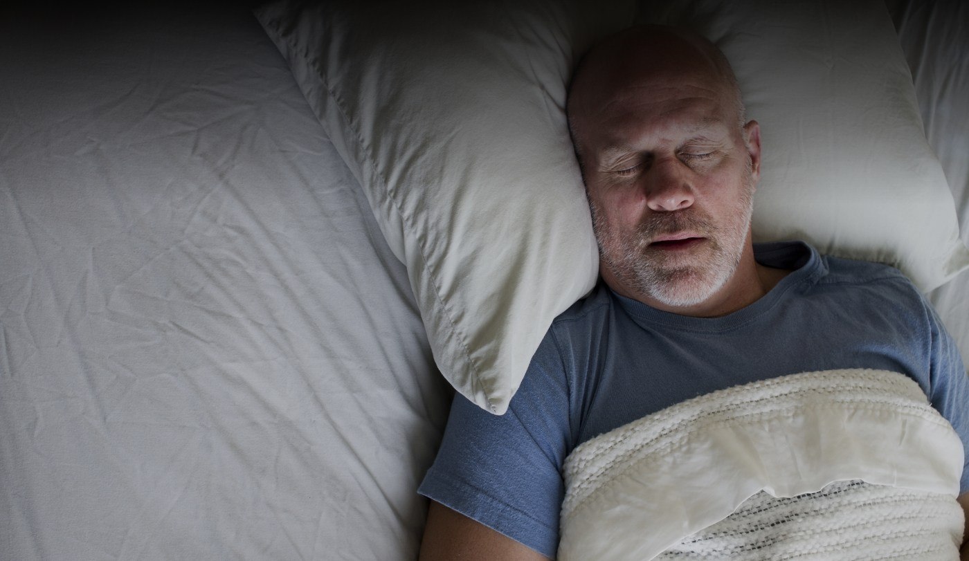 Man sleeping soundly thanks to sleep apnea therapy