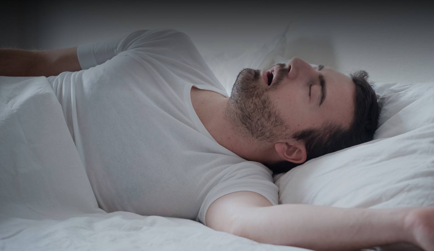 Snoring man in need of sleep apnea therapy