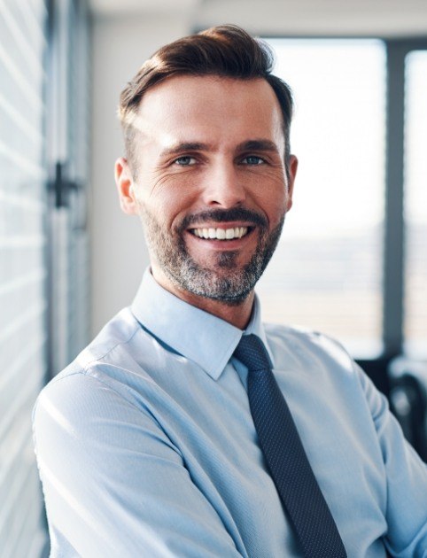 Man smiling after a good night's sleep using combined therapy