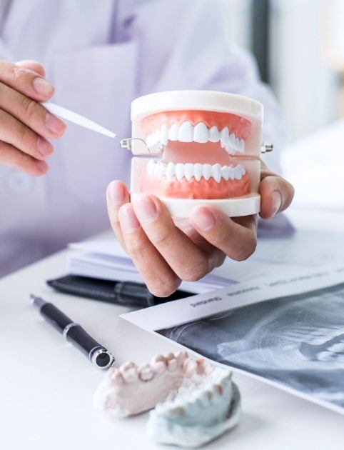 Dentist with advanced T M J dysfunction training discussing treatment with patient