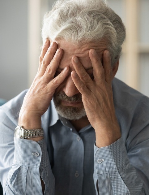Man with headache before migraine treatment