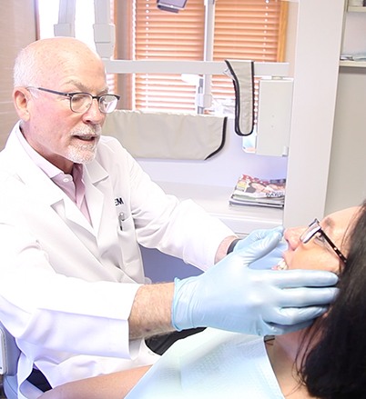 Doctor Michel examining dental patient