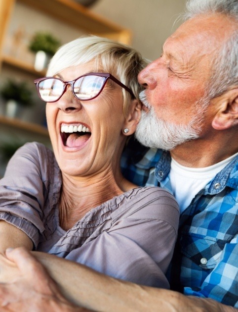 Man and woman smiling after achieving long term recovery from T M J disorder