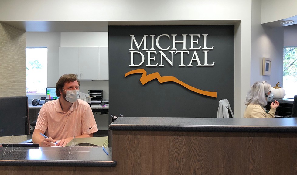 Friendly dental team member at front desk