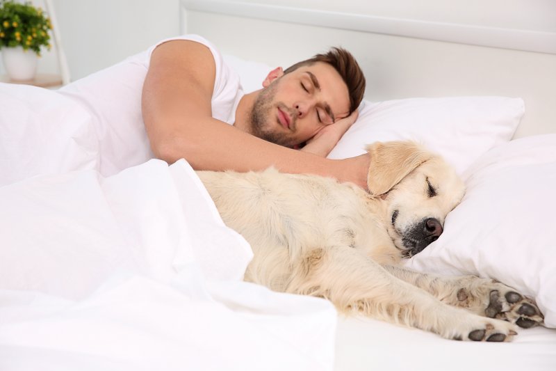 man resting with aid of oral sleep appliance in Topeka