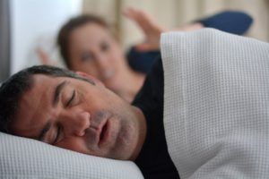 A patient snoring because of his sleep apnea