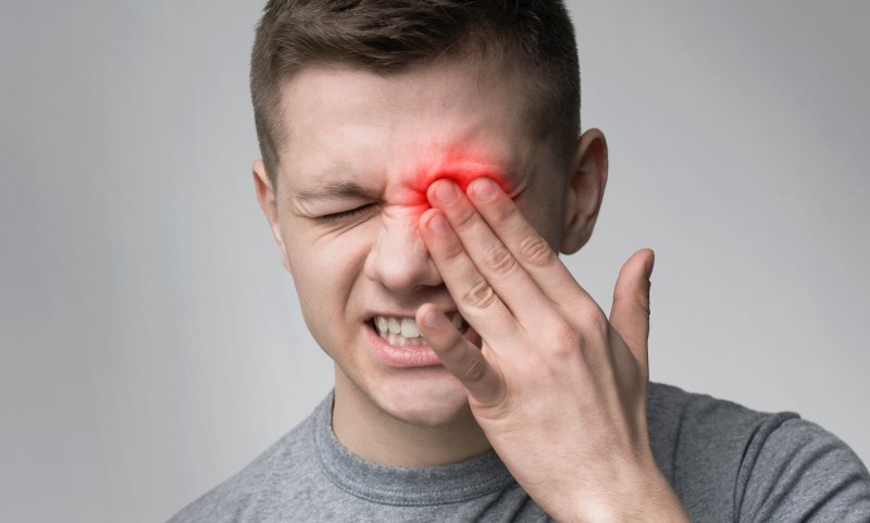 young man suffering from eye pain