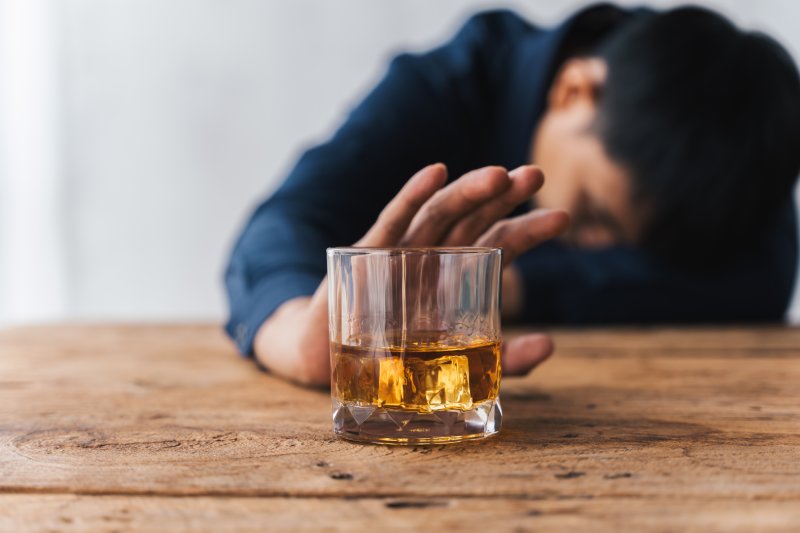 A man drinking as he drifts off, triggering his sleep apnea